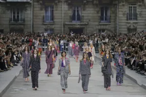 Models Josephine Le Tutour (2ndL), Binx Walton (3rdL) and Cara Delevingne (3rdR) present creations by German designer Karl Lagerfeld as part of his Spring/Summer 2015 women's ready-to-wear collection for French fashion house Chanel during Paris Fashion Week September 30, 2014. Karl Lagerfeld created an immense Boulevard Chanel for his fashion show on Tuesday, even staging a street demonstration by fashionably dressed models for Spring/Summer 2015.     REUTERS/Gonzalo Fuentes (FRANCE - Tags: FASHION)