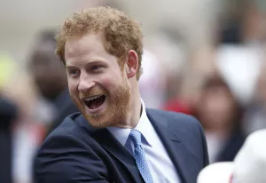 Britain's Prince Harry greets guests on the Mall as they attend the Patron's Lunch, an event to mark Queen Elizabeth's 90th birthday, in London