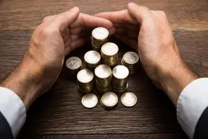 Businessman's Hand Protecting Euro Coins